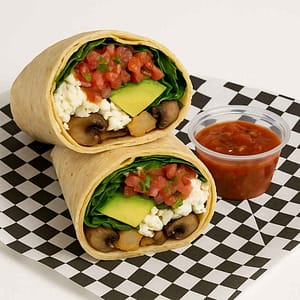 A hyper-realistic image of a Healthy Fresca Egg White Breakfast Burrito cut in half, filled with egg whites, fresh spinach, avocado slices, grilled mushrooms, and house-made salsa fresca inside a warm tortilla, served with a side of salsa on black-and-white checkered deli paper. Perfect for anyone searching for a Healthy Breakfast Burrito or Breakfast near me in Newport News.